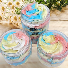 Body butter sugar scrub with colorful swirls, clear jars, and Mindbody Soaps text