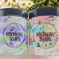 Soaps in clear jars with Mindbody Soaps label, colorful pastel shapes, and black lids