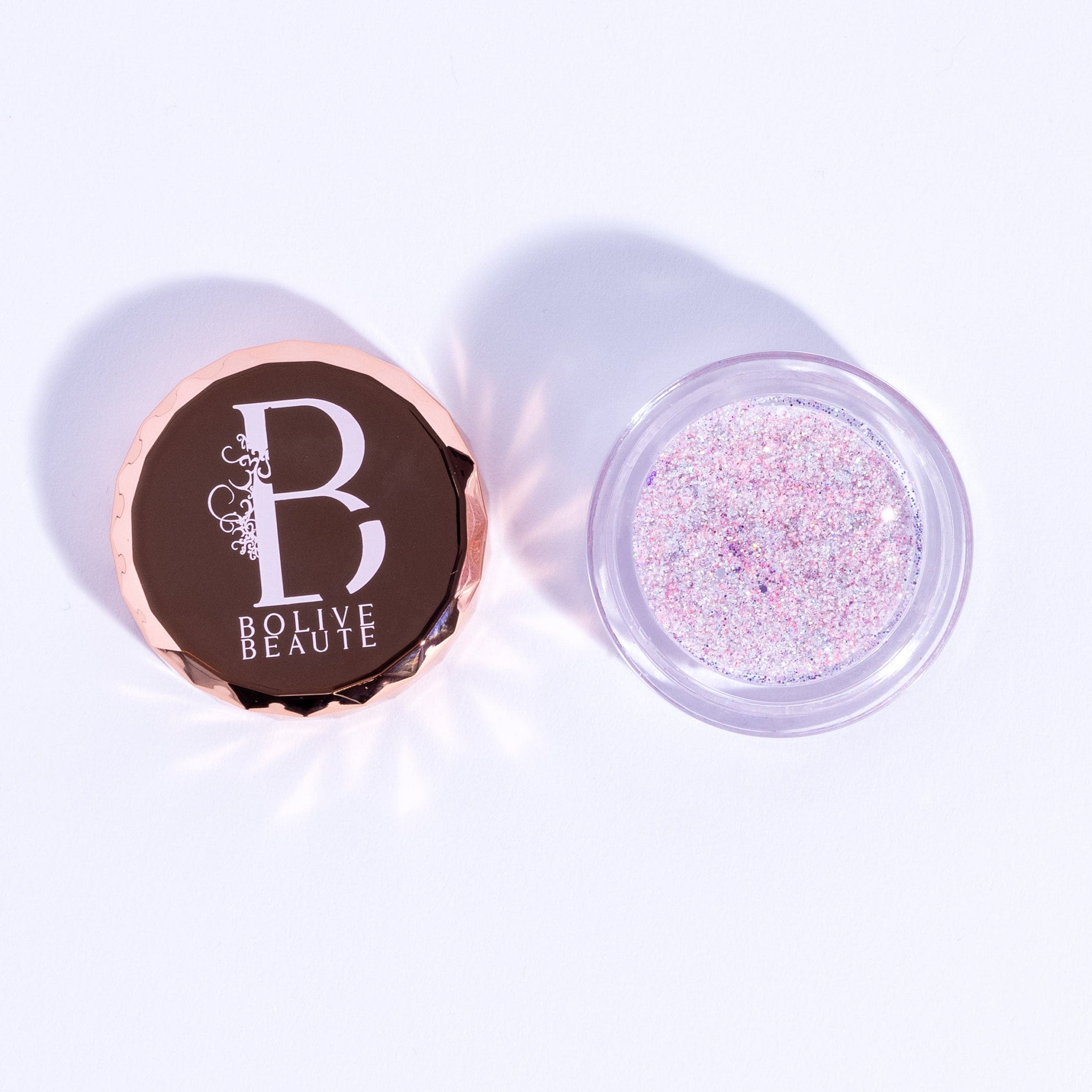 Pigmented iridescent pink glitter eyeshadow in compact with reflective fairy dust finish