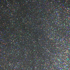 Close-up of holographic silver glitter eyeshadow with reflective shimmer particles in compact pan