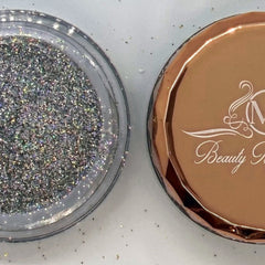 Side angle of holographic silver glitter eyeshadow pot catching light with prismatic reflections