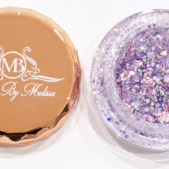 Glitter eyeshadow in purple and silver with MB By Melissa branding on a gold lid