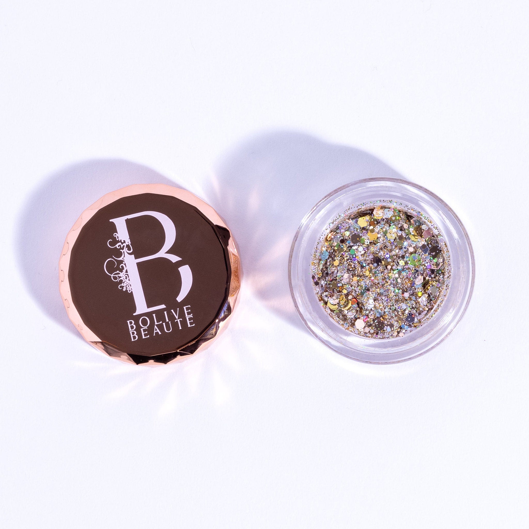Eye shadow glitter in clear jar, multi-color shimmer, and Bolive BEAUT logo on lid