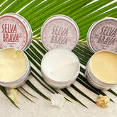 Skin care products in silver tins with visible Selva Brava branding and cream textures