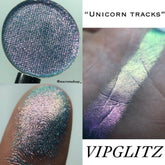 Multichrome Unicorn Tracks eyeshadow pan shifting between purple, teal, and gold hues with metallic finish.