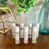 Lip balm tubes with floral patterns and white caps, Rudd Homestead LLC brand visible