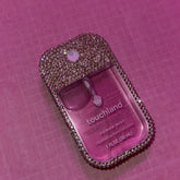 Hand sanitizer with pink liquid, crystal-covered case, and touchland branding