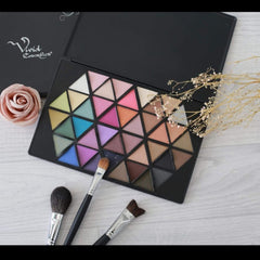Side view of Vivid Cosmetics eyeshadow palette showing sleek black case and vibrant color gradient from warm to cool tones