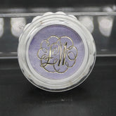 Eye shadow in aquamauve with gold lettering, in a clear plastic compact with white rim, Max Factor brand