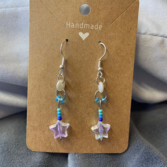 Close-up of star-shaped dangle eye shadow palette with vibrant rainbow hues and shimmer finish