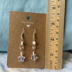 Side view of Colorful Stars Dangle Eye Shadow palette showing shimmering shades and star-shaped pendant details