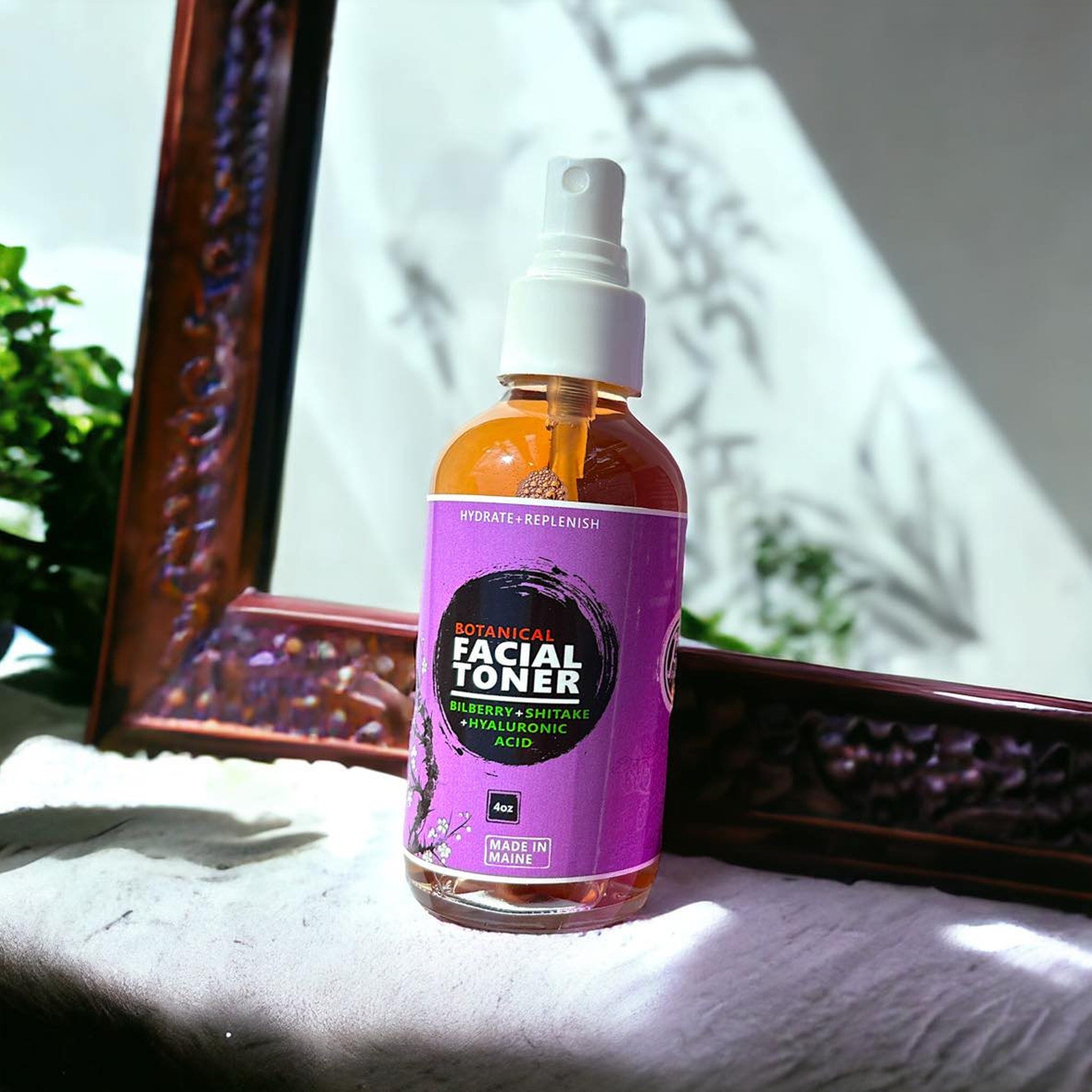 Toner spray bottle with white cap and purple label, on white surface with wooden frame