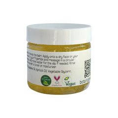 Balm jar with white lid, yellow contents, and white label with text and logos, for skincare use