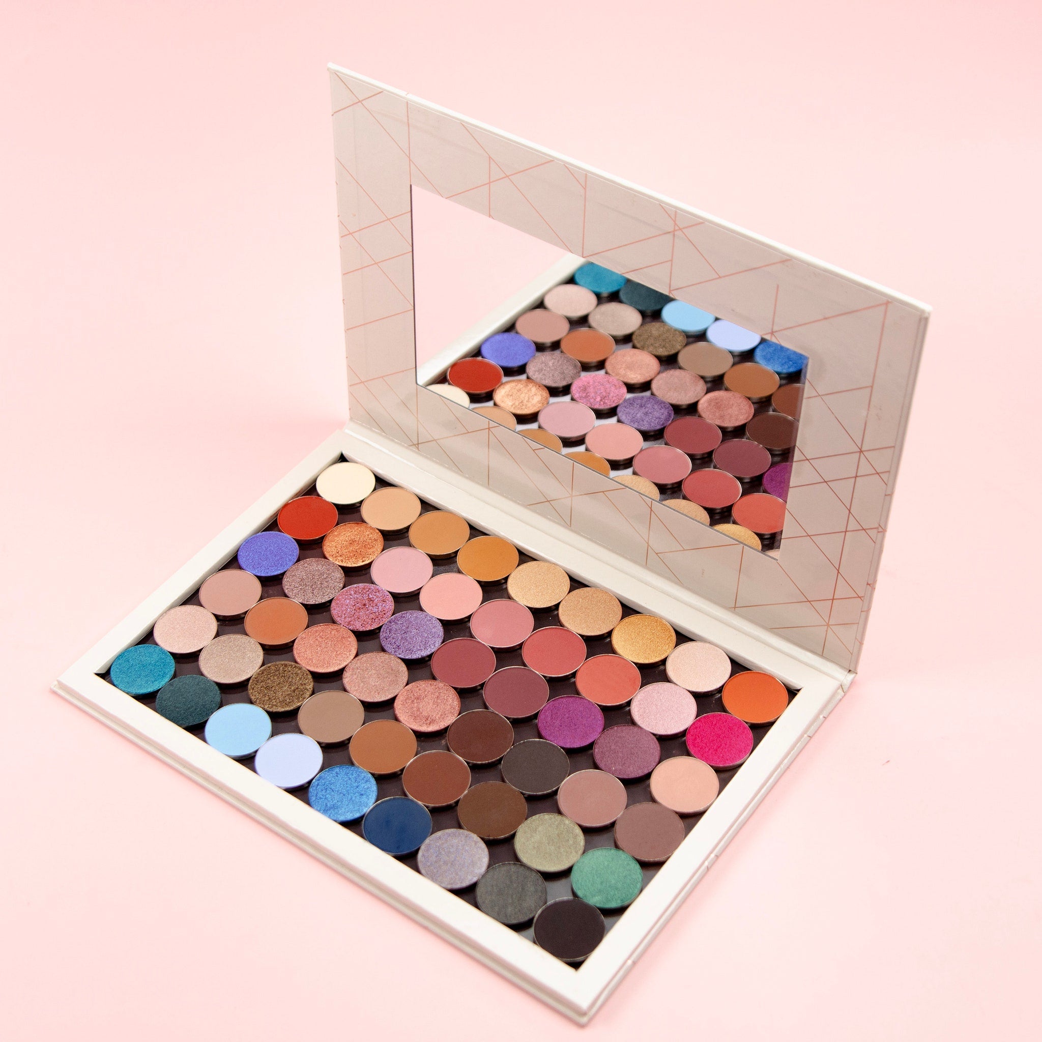 Open 54-pan eyeshadow palette displaying matte, shimmer, and pressed pigment squares in vibrant colors