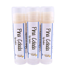 Lip balm tubes with white and blue labels, Pina Colada text, and clear caps