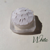 Soft white loose mineral eyeshadow with shimmer in a round compact, vegan highlighter base for subtle glow