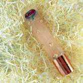 Lip balm tube with apple pattern, copper cap, and Sugar Me logo on packaging