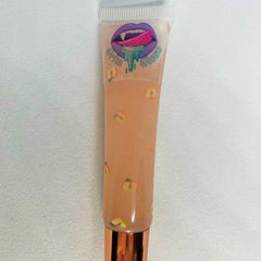 Lip gloss tube with peach colored liquid, apple pattern, and Grim Gloss logo on white background