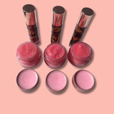 Lip balm set with pink and gold containers, pink lip gloss, and lip balm in jars