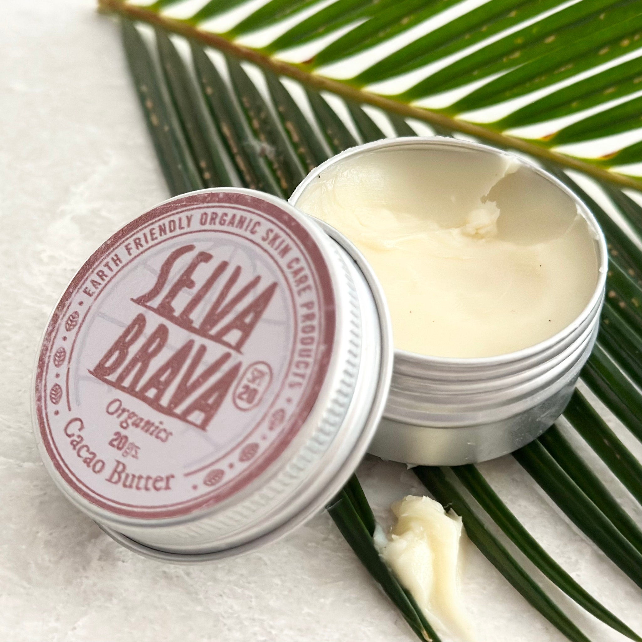 Lip balm in open silver tin with off-white balm and Selva Brava label visible