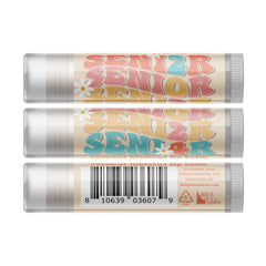 Lip balm with "SENIOR" text in retro style, with daisy accents and a white tube.