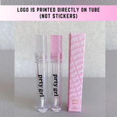 Lip gloss tubes with clear and pink lids, "prty grl" text, and pink packaging box