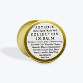 Lip balm tin, gold metal, white label with Abyrose text, product details