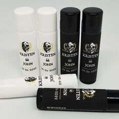 Lip balm tubes in white and black with skull design and text, Venus Complete LLC