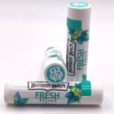 Mint lip balm tubes, white, teal and green floral design, Bonbon Balm brand