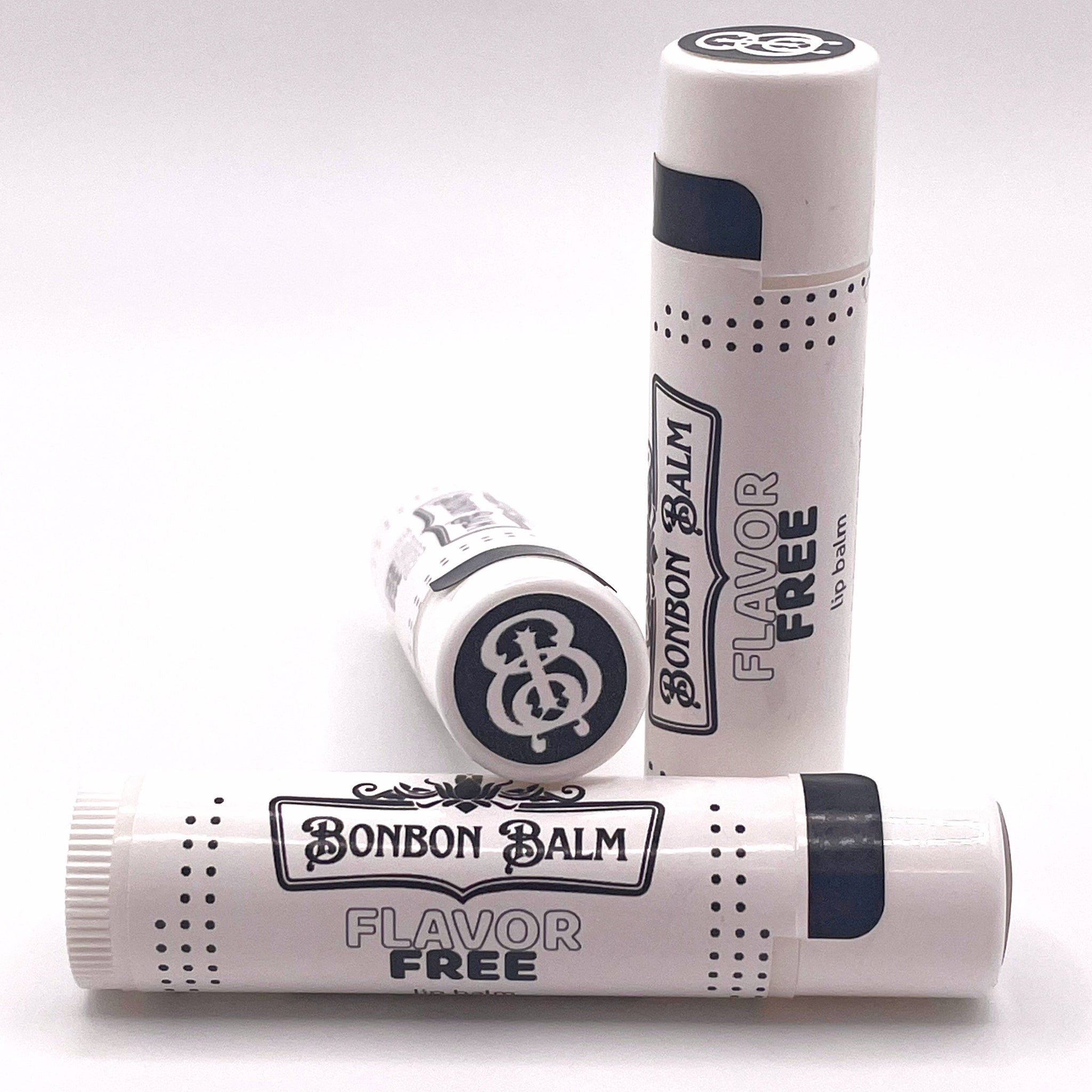 Lip balm tubes in white with black accents and Bonbon Balm text visible
