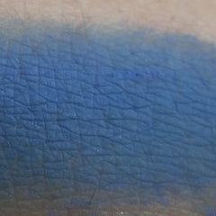 Side view of Pop Blue Sapphire matte eyeshadow pan showing rich pigment depth and smooth texture