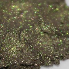 Glittery green and brown material with sparkling highlights and rough texture
