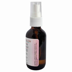 Facial oil bottle with brown glass, white spray top, and label with text