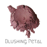 Shimmery pink vegan mineral eyeshadow in compact with gold-toned lid, showcasing soft petal hue and reflective finish