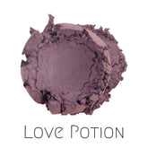 Close-up of Vegan Mineral Eyeshadow in Love Potion - a shimmering purple powder with eco-friendly packaging