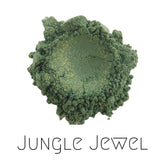 Close-up of vegan green and gold sparkle eyeshadow in Jungle Jewel shade, showcasing shimmering mineral pigments in compact.