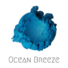 Close-up of Shimmering Ocean Breeze eyeshadow palette showing vibrant blue-green teal pigment with metallic finish