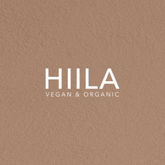 HIILA logo on textured brown background with white text, vegan & organic branding