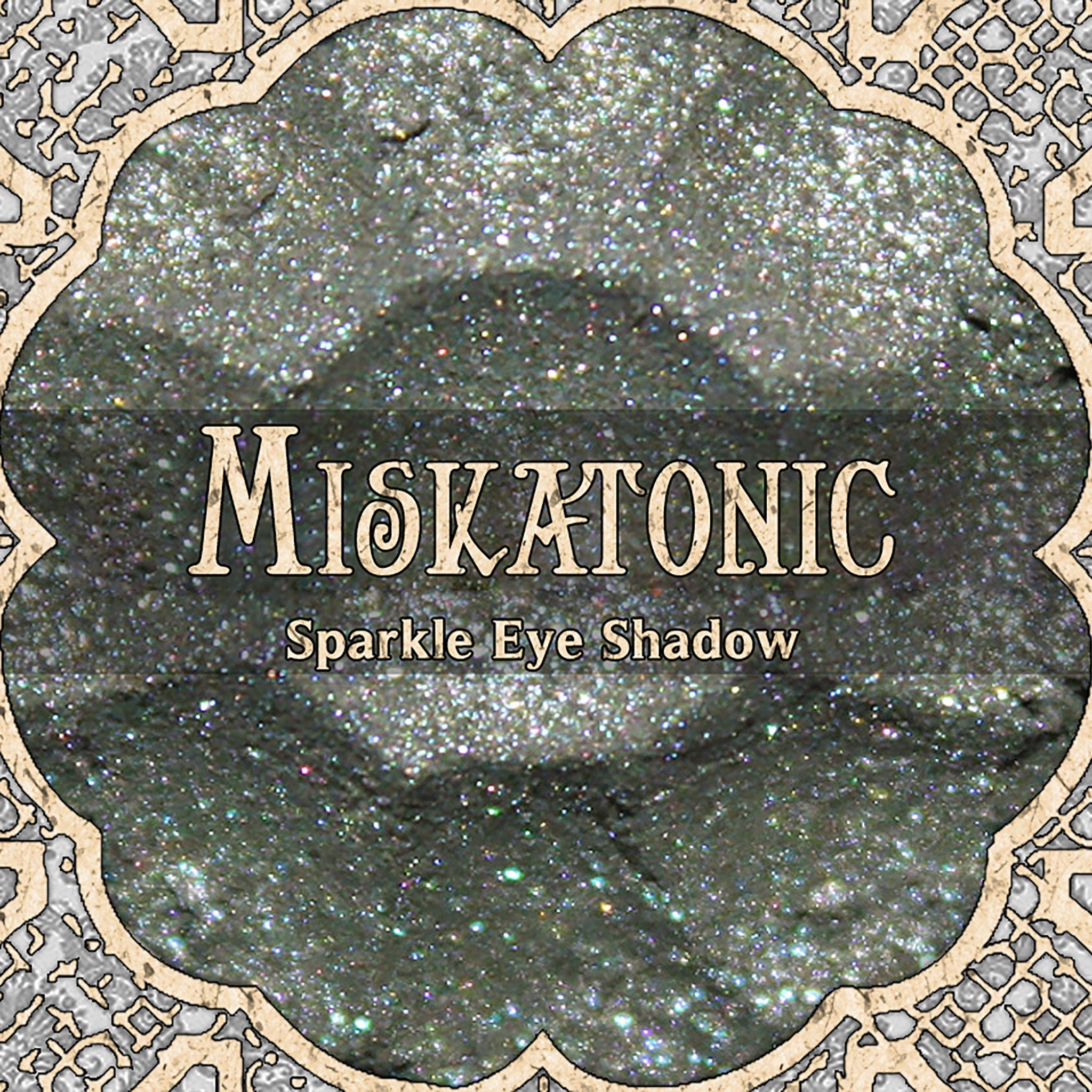 Eye makeup shimmer shadow, grey with sparkle, MISKATONIC brand name visible in ornate frame