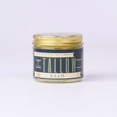 Tallow balm jar with gold lid, blue label, and Lady May text visible