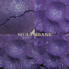 Purple glitter eyeshadow with cracked texture, "WOLFSBANE" text visible
