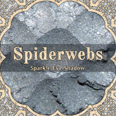 Pale silver blue vegan loose powder eyeshadow with sparkle, shown in open jar with soft pastel reflections