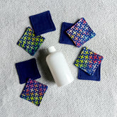 Makeup remover pads, navy and patterned fabric, with white bottle on towel
