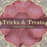 Light cerise pink loose powder eyeshadow with blue duochrome shimmer in open jar