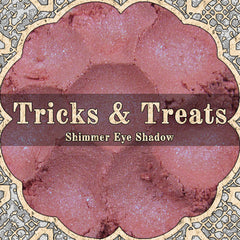 Light cerise pink loose powder eyeshadow with blue duochrome shimmer in open jar