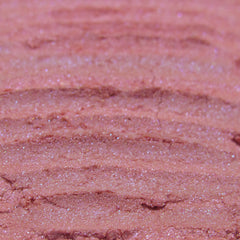 Side view of loose powder eye shadow in light cerise pink with blue duochrome shimmer, vegan Halloween makeup