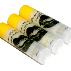 Lip scrub tubes with yellow caps, white labels, and black lip print, BANANA brand visible