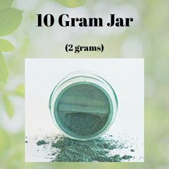 Close-up of fingertips applying shimmery bronze vegan eyeshadow to eyelid crease for natural daytime look