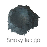 Vegan eyeshadow duo in smoky indigo and shimmery deep aubergine shades with eco-friendly compact packaging