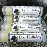 Lip balm tubes with clear plastic, yellow balm, and Doc Holliday label